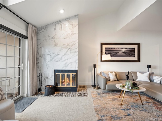 living room with a premium fireplace, recessed lighting, and carpet