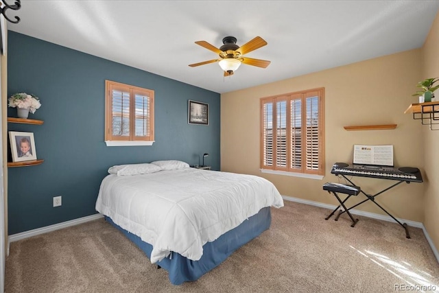 carpeted bedroom with ceiling fan and multiple windows