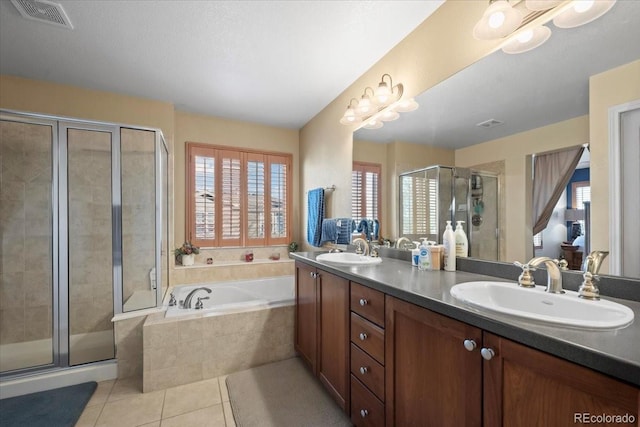 bathroom with tile patterned floors, vanity, and independent shower and bath