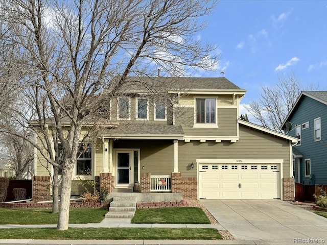 view of front of home featuring a front yard, a porch, and a garage