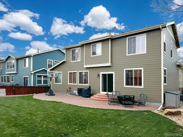 rear view of house featuring a lawn and a patio area