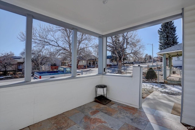 unfurnished sunroom featuring a wealth of natural light