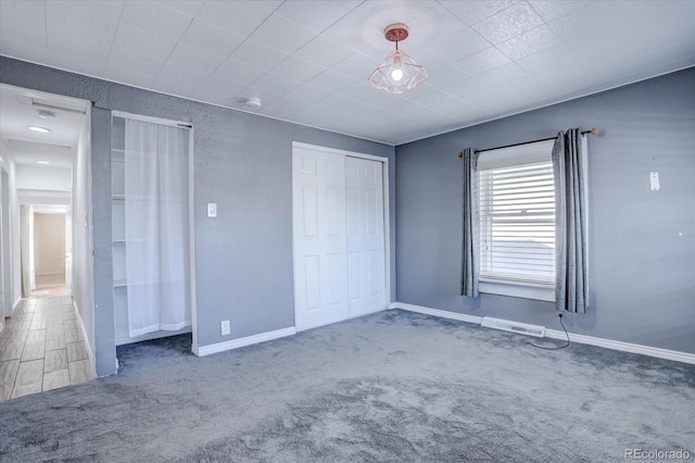 unfurnished bedroom featuring a closet and carpet floors