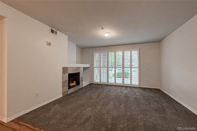 804 Summer Hawk Dr Unit 5105, Longmont, CO 80504 - unfurnished living room featuring a tiled fireplace, carpet floors, and baseboards