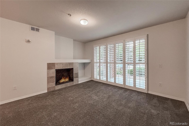 804 Summer Hawk Dr Unit 5105, Longmont, CO 80504 - unfurnished living room with dark colored carpet, a tiled fireplace, and baseboards