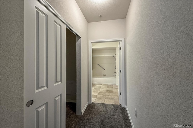 804 Summer Hawk Dr Unit 5105, Longmont, CO 80504 - corridor with a textured wall, carpet flooring, and baseboards