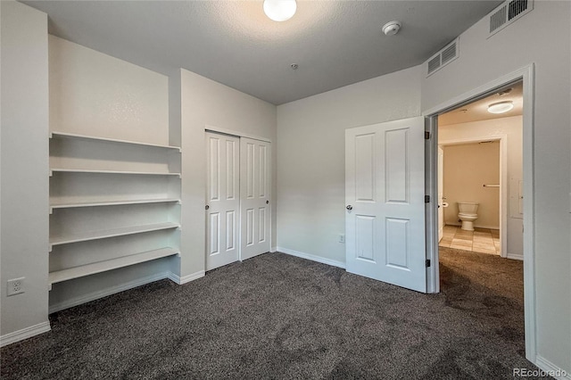 804 Summer Hawk Dr Unit 5105, Longmont, CO 80504 - unfurnished bedroom featuring dark colored carpet, a closet, and baseboards
