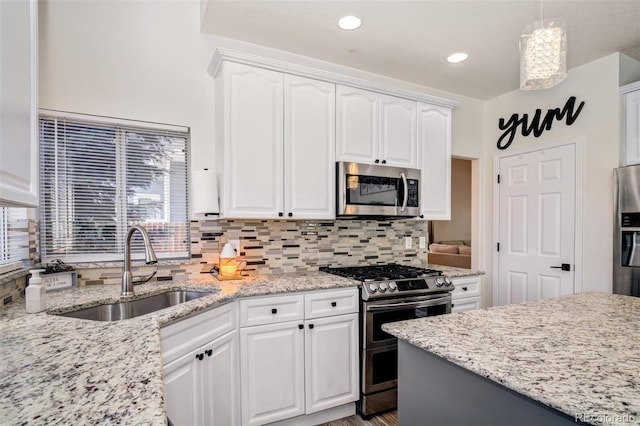 16084 Stonebriar Dr, Parker, CO 80134 - kitchen featuring appliances with stainless steel finishes, a sink, white cabinets, and recessed lighting