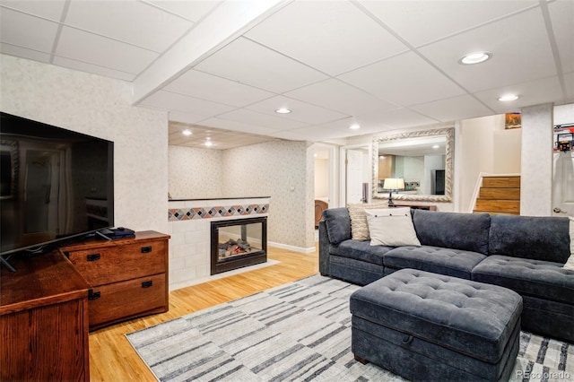 16084 Stonebriar Dr, Parker, CO 80134 - living room with wood finished floors, wallpapered walls, stairway, a fireplace, and recessed lighting