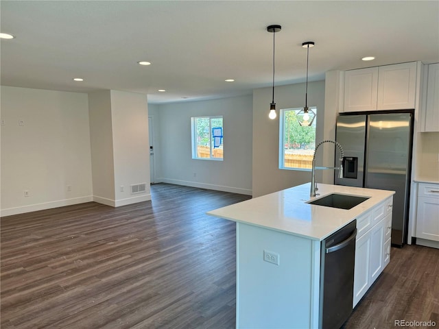 kitchen with stainless steel refrigerator with ice dispenser, dishwasher, sink, white cabinetry, and a center island with sink