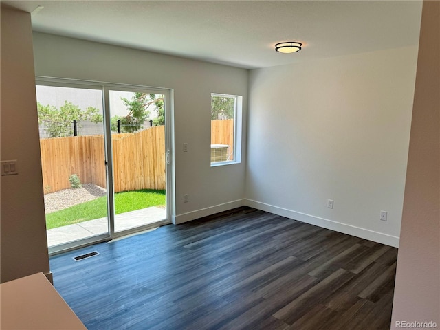 unfurnished room featuring dark wood-type flooring