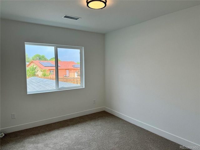 unfurnished room with baseboards, visible vents, and carpet floors