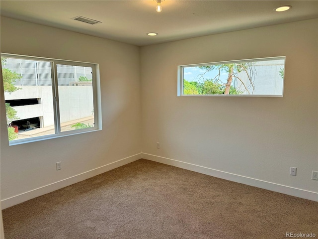 empty room with recessed lighting, visible vents, baseboards, and carpet