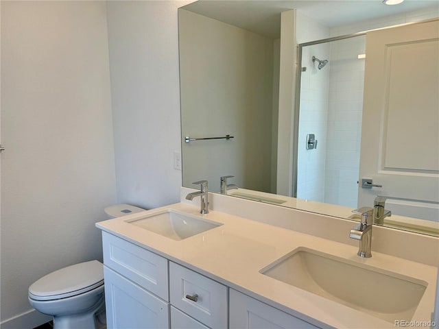 bathroom featuring tiled shower, toilet, and vanity