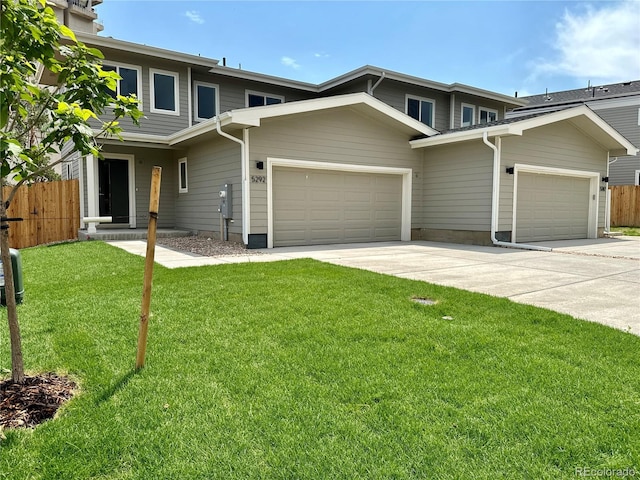 front facade featuring a garage and a front lawn