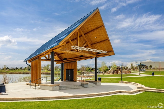 view of property's community with a gazebo, a yard, and a water view