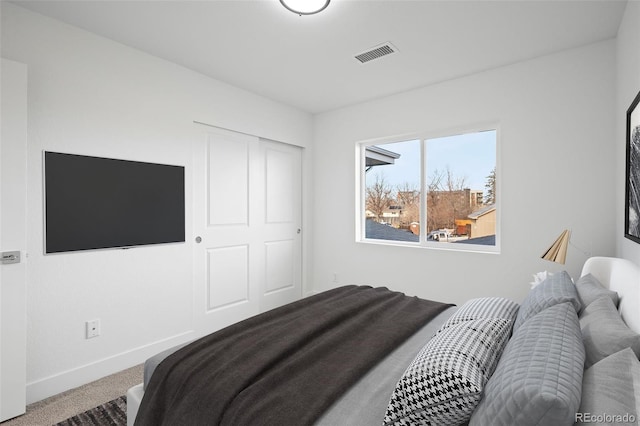carpeted bedroom with baseboards and visible vents
