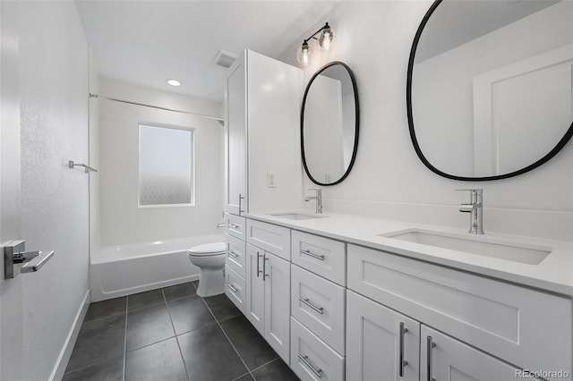 full bathroom with toilet, tile patterned flooring, a sink, and baseboards