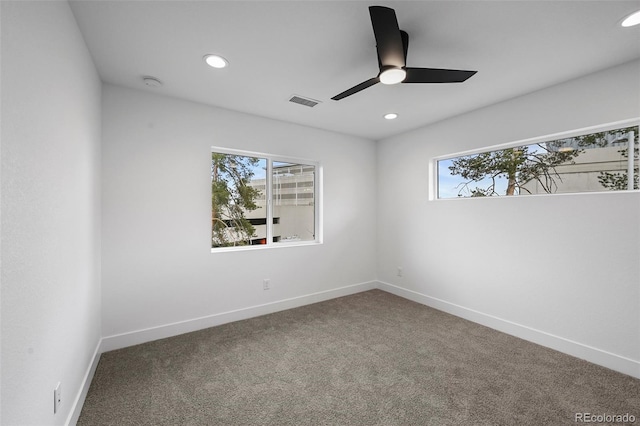 carpeted empty room with a ceiling fan, a wealth of natural light, and recessed lighting