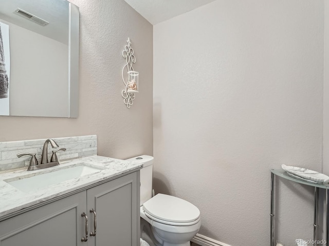 13358 Briarwood Dr, Broomfield, CO 80020 - bathroom featuring vanity, toilet, and a textured wall