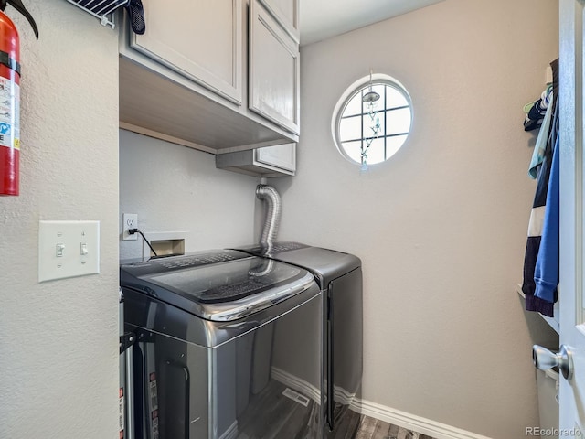 13358 Briarwood Dr, Broomfield, CO 80020 - clothes washing area featuring separate washer and dryer, cabinet space, dark wood-type flooring, and baseboards