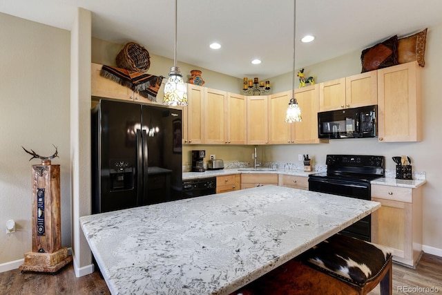 kitchen with decorative light fixtures, light brown cabinets, dark hardwood / wood-style flooring, black appliances, and sink