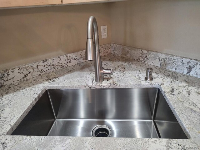 details featuring sink and light stone counters