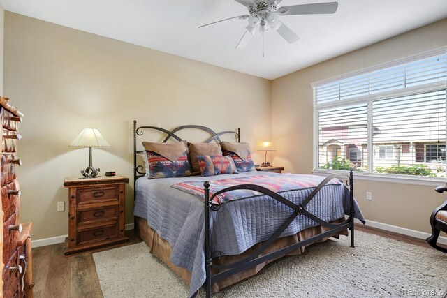 bedroom featuring wood-type flooring and ceiling fan