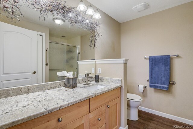 bathroom featuring hardwood / wood-style floors, toilet, and vanity