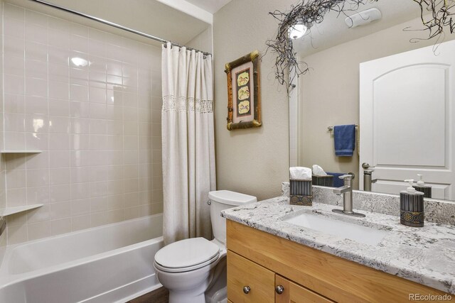 full bathroom featuring shower / bathtub combination with curtain, large vanity, and toilet