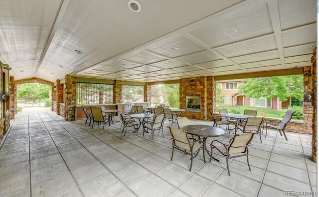 view of patio with an outdoor brick fireplace