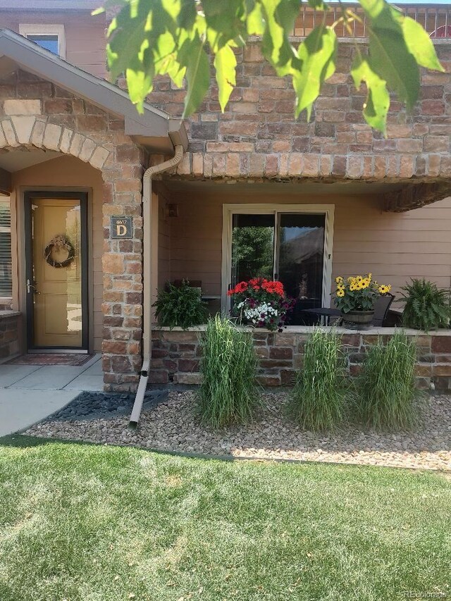 doorway to property with a yard