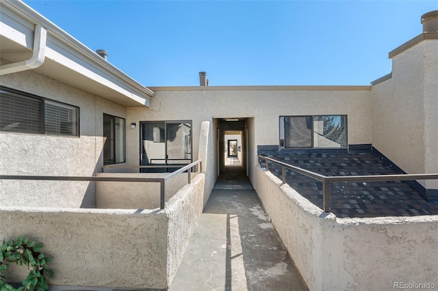 doorway to property featuring stucco siding