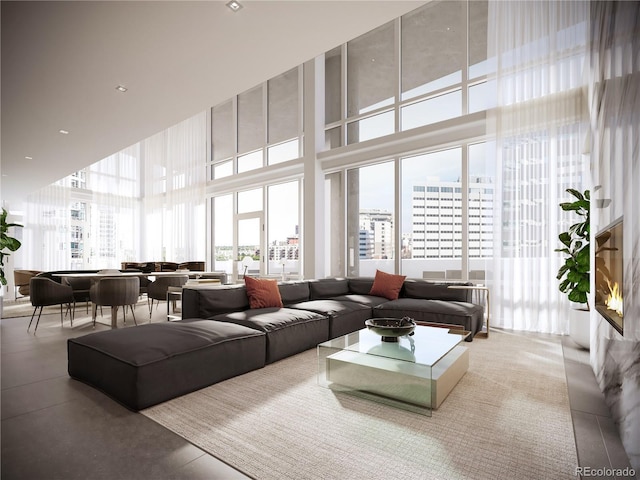 living room with a towering ceiling and a city view