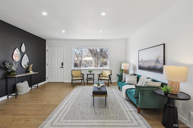 living room featuring recessed lighting, baseboards, and wood finished floors