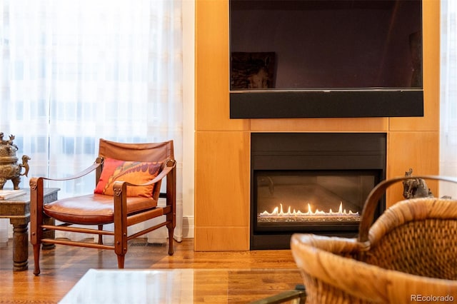 sitting room with hardwood / wood-style flooring