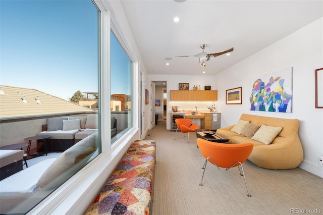 carpeted living room with wine cooler and ceiling fan