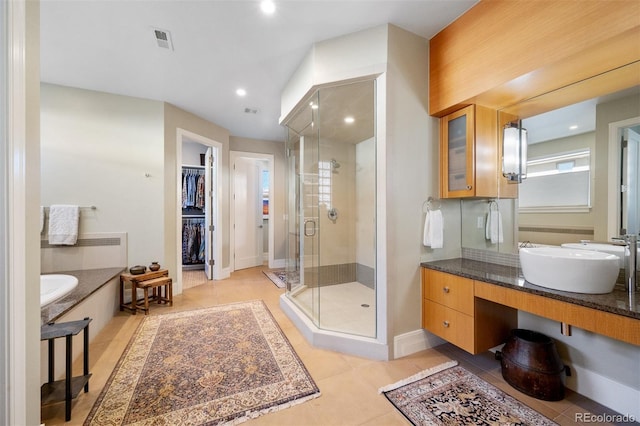 bathroom featuring a shower stall, tile patterned floors, a bath, a spacious closet, and recessed lighting