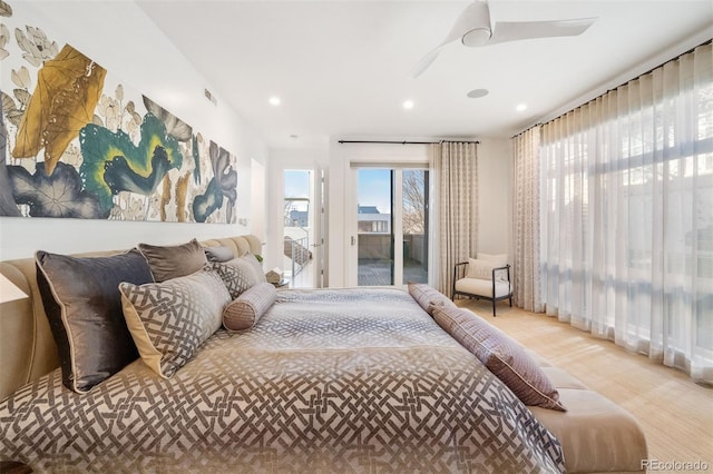 bedroom featuring access to outside, recessed lighting, and wood finished floors