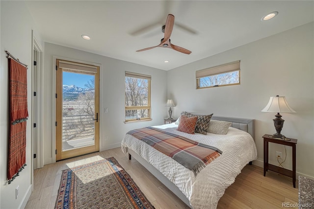 bedroom featuring baseboards, light wood finished floors, and access to exterior