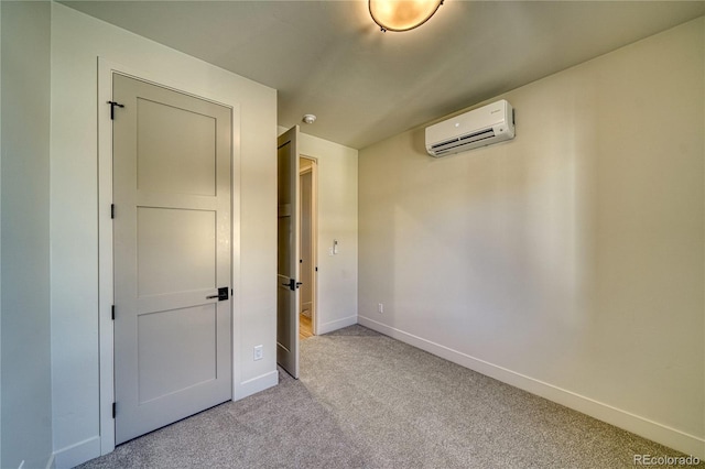 unfurnished bedroom featuring carpet floors, baseboards, and a wall mounted AC