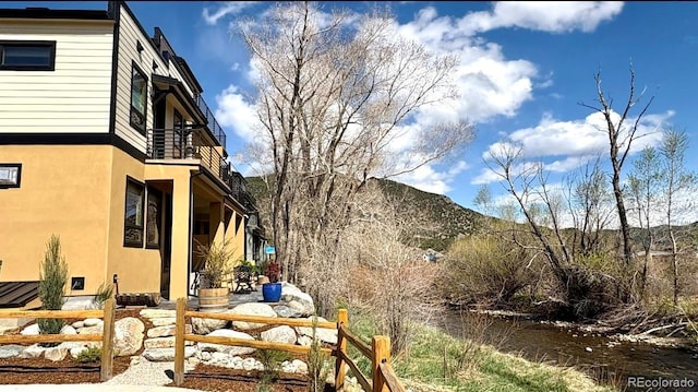 view of yard with a mountain view and a balcony