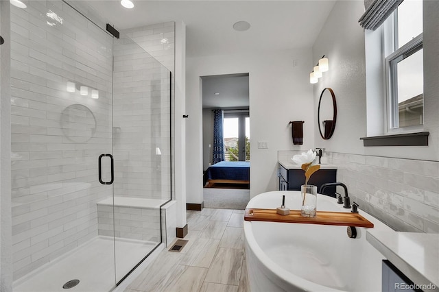 21345 E 59th Dr, Aurora, CO 80019 - bathroom with ensuite bath, a stall shower, vanity, and a freestanding bath