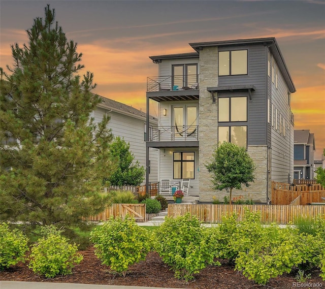 21345 E 59th Dr, Aurora, CO 80019 - back of property featuring a balcony and stone siding
