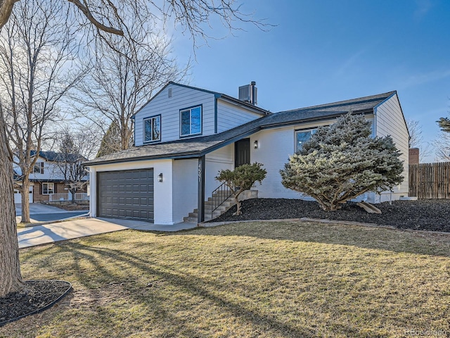 view of front of home featuring a garage, concrete driveway, and a front lawn