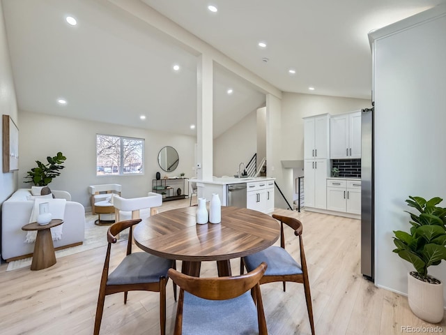 dining area featuring vaulted ceiling with beams, light wood-type flooring, and recessed lighting