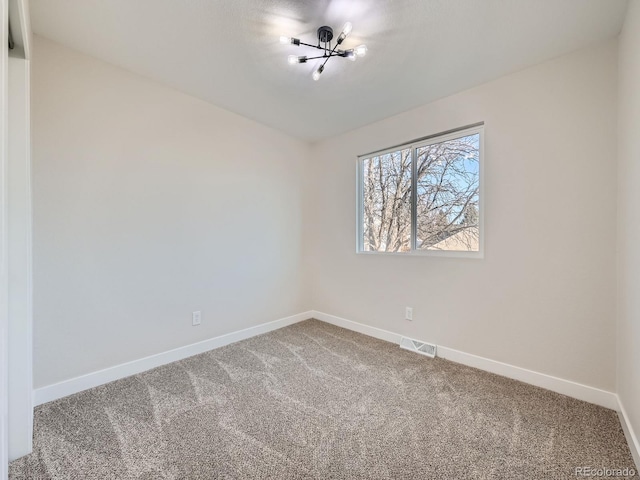 unfurnished room with baseboards, visible vents, and carpet flooring