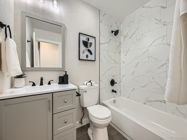 full bath featuring washtub / shower combination, a textured wall, vanity, and toilet