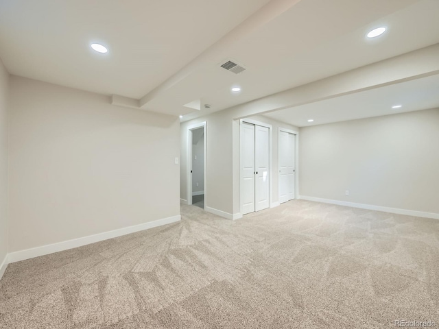 finished basement featuring light colored carpet, visible vents, baseboards, and recessed lighting