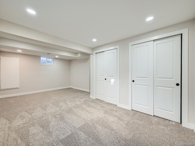 basement featuring carpet, baseboards, and recessed lighting